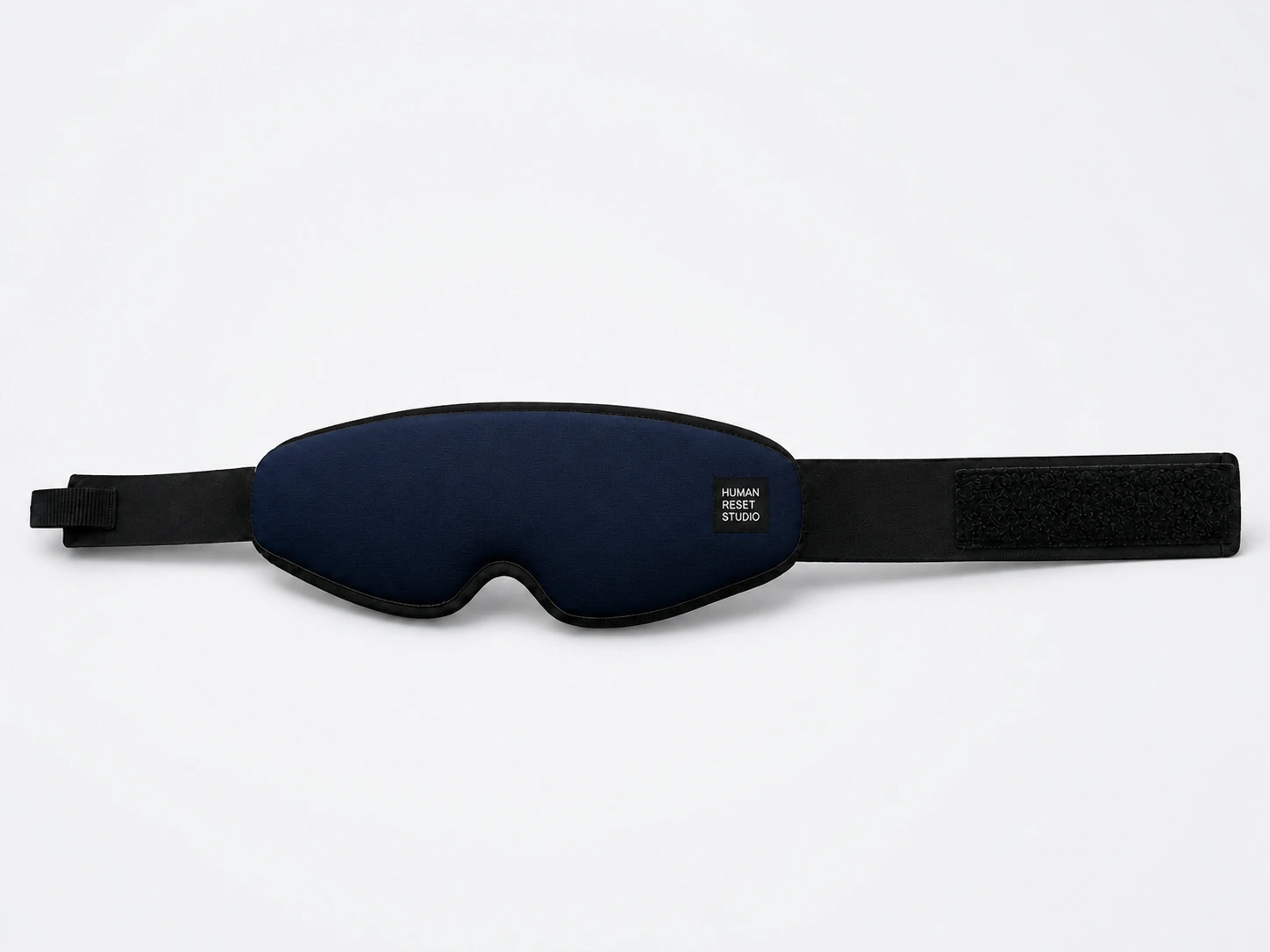 Navy textile eye wrap with black binding and adjustable closure